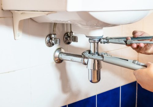 Plumber,Fixes,Sink,Siphon,By,Two,Pipe-wrenches,In,Bathroom